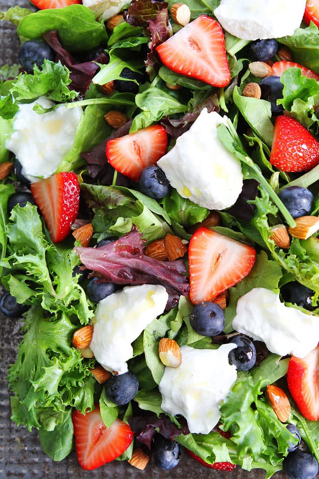 Berry, Burrata, and Almond Salad Recipe on twopeasandtheirpod.com Mixed greens topped with blueberries, strawberries, burrata cheese, almonds, and a simple honey lemon dressing! This easy salad is perfect for the 4th of July! Berry, Burrata, and Almond Salad Recipe