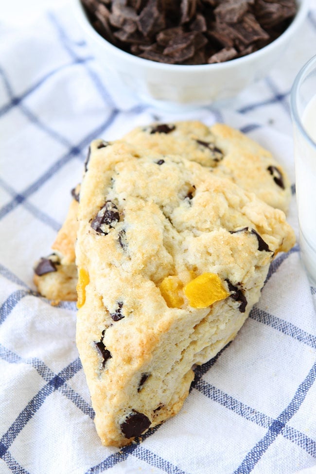 Mango Dark Chocolate Chunk Scones Recipe on twopeasandtheirpod.com These buttery cream scones with fresh mango and dark chocolate chunks make a great breakfast treat! Mango Dark Chocolate Chunk Scones Recipe