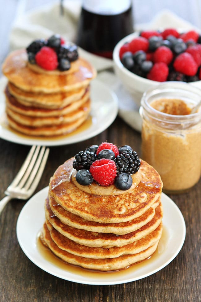 Almond Butter Pancakes Recipe on twopeasandtheirpod.com You will LOVE these easy whole wheat protein pancakes! They make a great healthy breakfast and they freeze beautifully too! Almond Butter Pancakes with berries, almond butter, and maple syrup