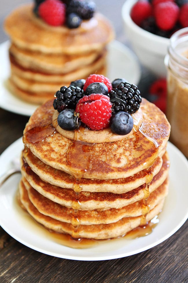 Almond Butter Pancakes Recipe on twopeasandtheirpod.com These whole wheat protein pancakes make a great healthy breakfast! They freeze beautifully too! Stack of Almond Butter Pancakes with berries and syrup