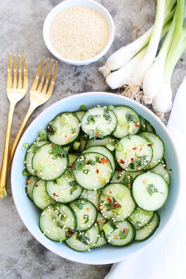 This easy and healthy Asian Cucumber Salad only takes minutes to make. It is a great side dish to any meal. Cucumber Salad ready to serve with red pepper flakes and sesame seeds