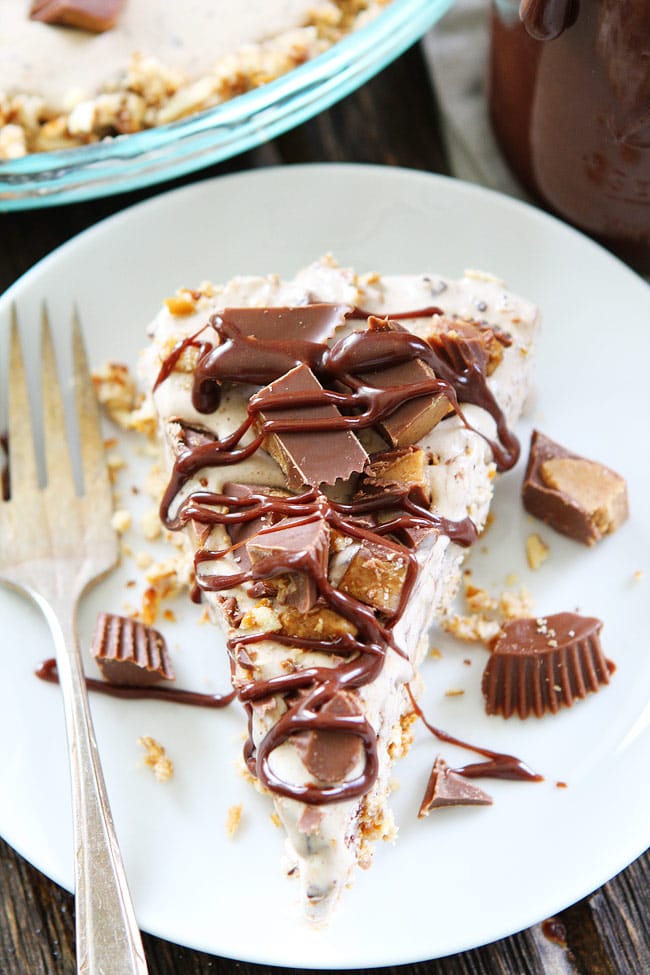 Peanut Butter Pretzel Ice Cream Pie Recipe on twopeasandtheirpod.com A salty pretzel crust filled with Moose Tracks ice cream then topped with peanut butter cups and drizzled with peanut butter hot fudge sauce! You will LOVE this sweet and salty ice cream pie! Peanut Butter Pretzel Ice Cream Pie Recipe