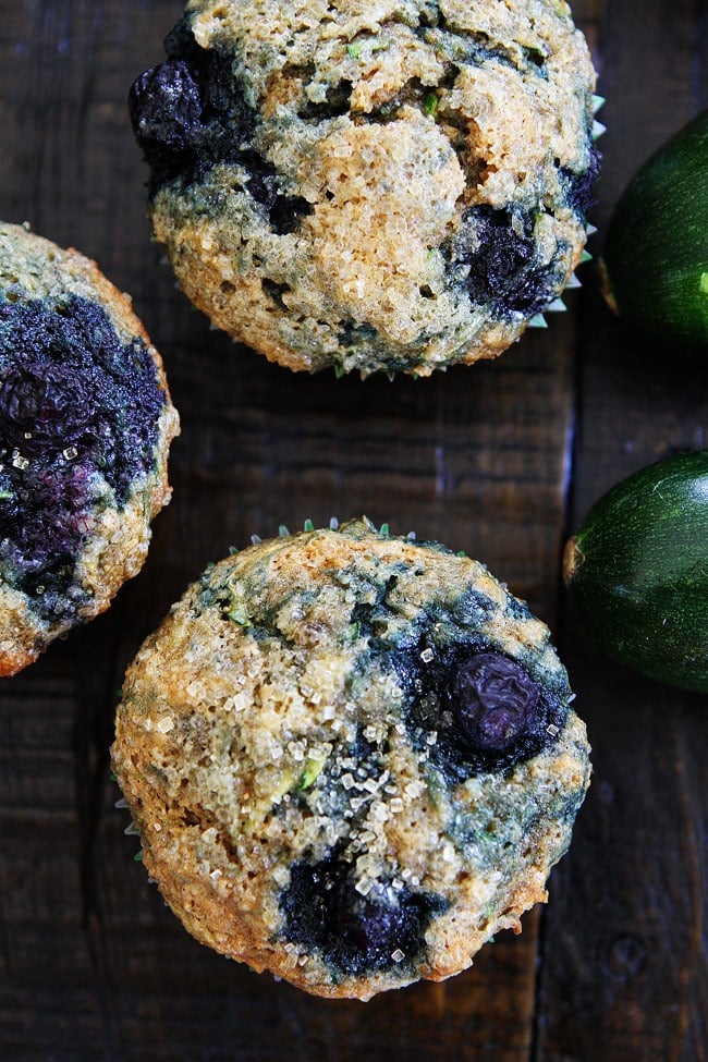 Zucchini Banana Blueberry Muffin Recipe on twopeasandtheirpod.com Use your summer zucchini to make these nutritious and delicious muffins! They are easy to make and freeze beautifully! Zucchini Banana Blueberry Muffins on wood table.