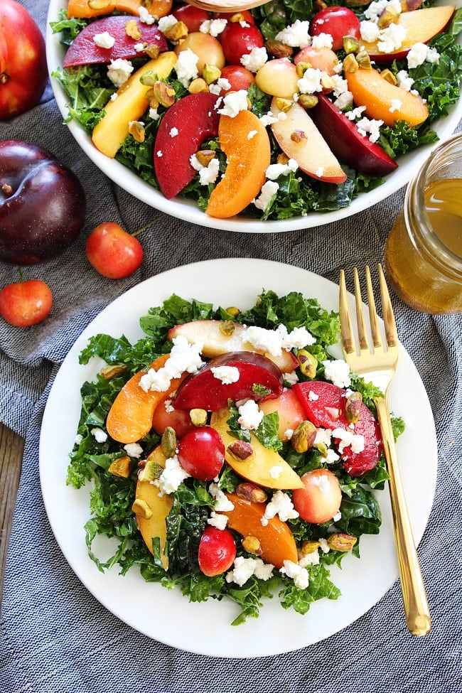 Stone Fruit Kale Salad Recipe on twopeasandtheirpod.com This simple kale salad is loaded with summer stone fruit, goat cheese, and pistachios. It is the perfect side for all of your summer BBQ's, picnics, and potlucks. Stone Fruit Kale Salad Recipe