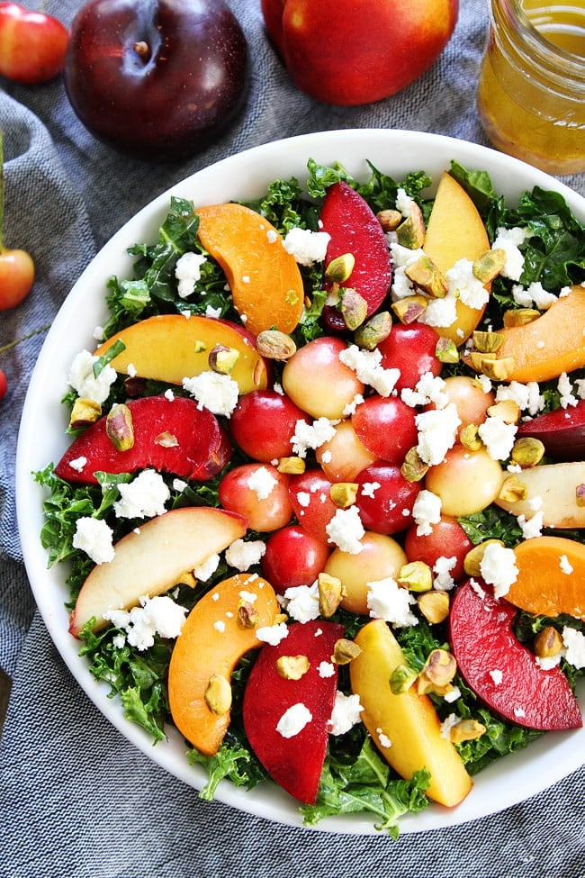 Stone Fruit Kale Salad Recipe on twopeasandtheirpod.com This simple kale salad is loaded with summer stone fruit, goat cheese, and pistachios. It is the perfect salad for summertime. Stone Fruit Kale Salad Recipe