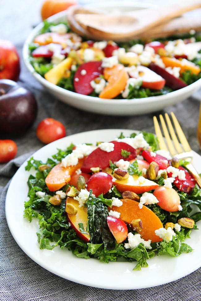 Stone Fruit Kale Salad Recipe on twopeasandtheirpod.com This simple and beautiful kale salad is loaded with summer stone fruit, goat cheese, and pistachios. It is the perfect side to all of your summer meals. Stone Fruit Kale Salad Recipe