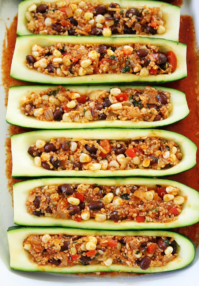 Black Bean and Quinoa Enchilada Zucchini Boats Recipe on twopeasandtheirpod.com If you like enchiladas, you will love these easy and healthy enchilada zucchini boats. The BEST way to use up your summer zucchini! Black Bean and Quinoa Enchilada Zucchini Boats Recipe