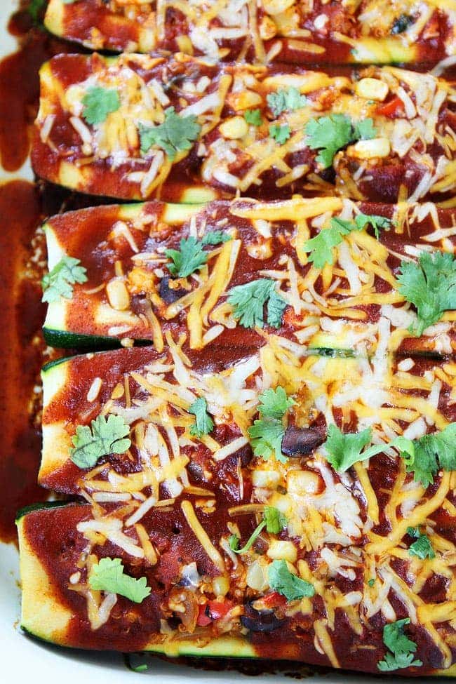 Black Bean and Quinoa Enchilada Zucchini Boats Recipe on twopeasandtheirpod.com This quick and easy dinner recipe is a family favorite and it's a great way to use up the summer zucchini! Black Bean and Quinoa Enchilada Zucchini Boats Recipe