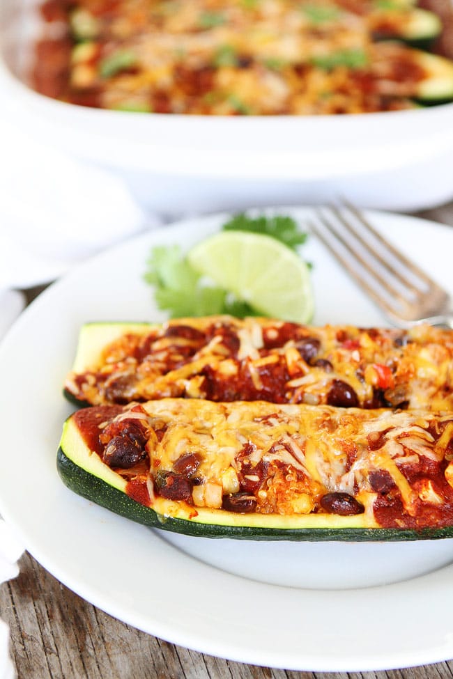Black Bean and Quinoa Enchilada Zucchini Boats Recipe on twopeasandtheirpod.com This quick and easy dinner recipe is a family favorite and it's a great way to use up the summer zucchini! Black Bean and Quinoa Enchilada Zucchini Boats Recipe