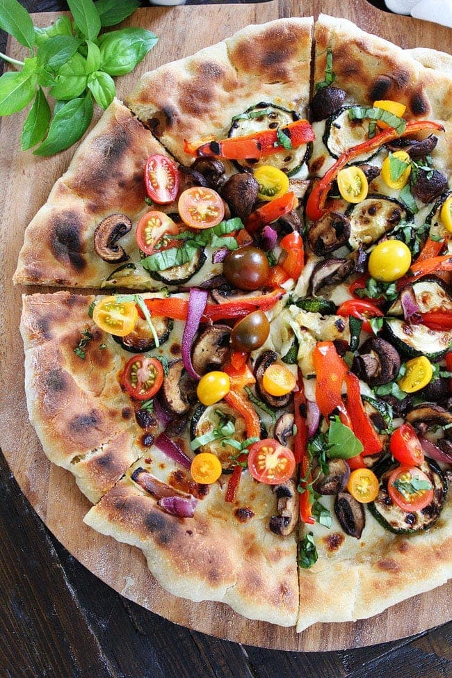 Garlic Butter Grilled Vegetable Pizza Recipe on twopeasandtheirpod.com Pizza brushed with garlic butter and topped with grilled vegetables, fresh mozzarella, and basil. This pizza is full of flavor and perfect for summertime! Garlic Butter Grilled Vegetable Pizza