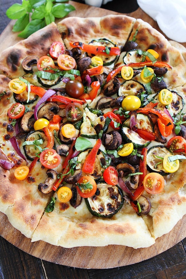 Garlic Butter Grilled Vegetable Pizza Recipe on twopeasandtheirpod.com Pizza brushed with garlic butter and topped with grilled vegetables, fresh mozzarella, and basil. This pizza is full of flavor and perfect for summertime! Garlic Butter Grilled Vegetable Pizza Recipe