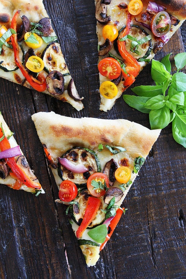 Garlic Butter Grilled Vegetable Pizza Recipe on twopeasandtheirpod.com Pizza brushed with garlic butter and topped with grilled vegetables, fresh mozzarella, and basil. This pizza is perfect for summertime! Garlic Butter Grilled Vegetable Pizza Recipe