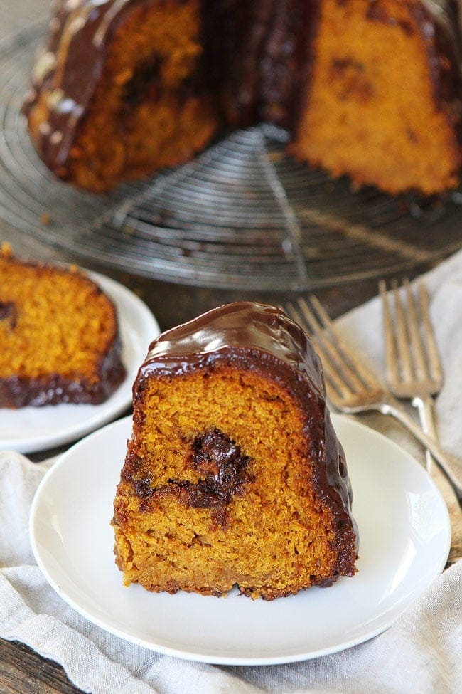 Pumpkin Truffle Bundt Cake with Chocolate Ganache Recipe on twopeasandtheirpod.com Pumpkin bundt cake with chocolate ganache and a tunnel of pumpkin spice truffles inside! This cake is the perfect fall dessert! Pumpkin Truffle Bundt Cake with Chocolate Ganache Recipe
