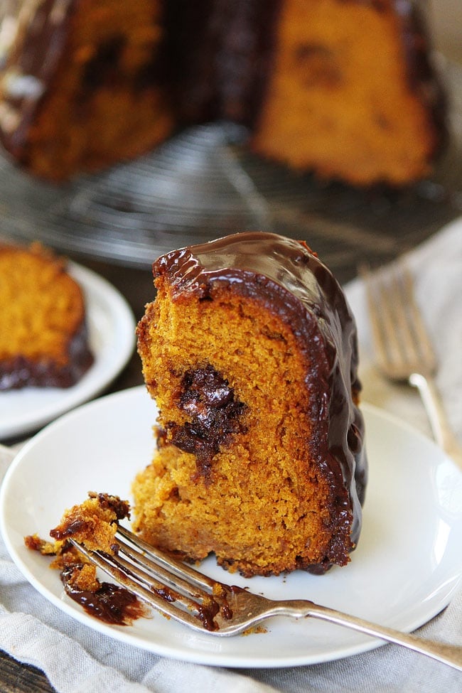 Pumpkin Truffle Bundt Cake with Chocolate Ganache Recipe on twopeasandtheirpod.com The BEST pumpkin cake recipe! Pumpkin Truffle Bundt Cake with Chocolate Ganache Recipe