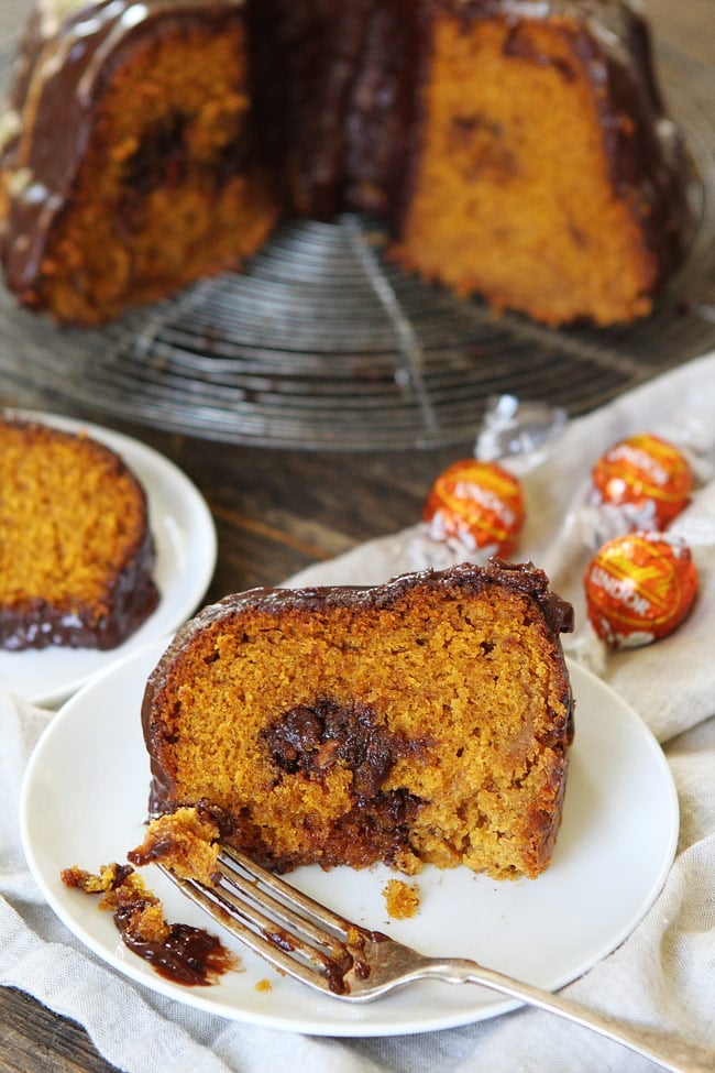 Pumpkin Truffle Bundt Cake with Chocolate Ganache Recipe on twopeasandtheirpod.com Pumpkin bundt cake with chocolate ganache and a tunnel of pumpkin spice truffles inside! This cake is the perfect fall dessert! Pumpkin Truffle Bundt Cake with Chocolate Ganache Recipe