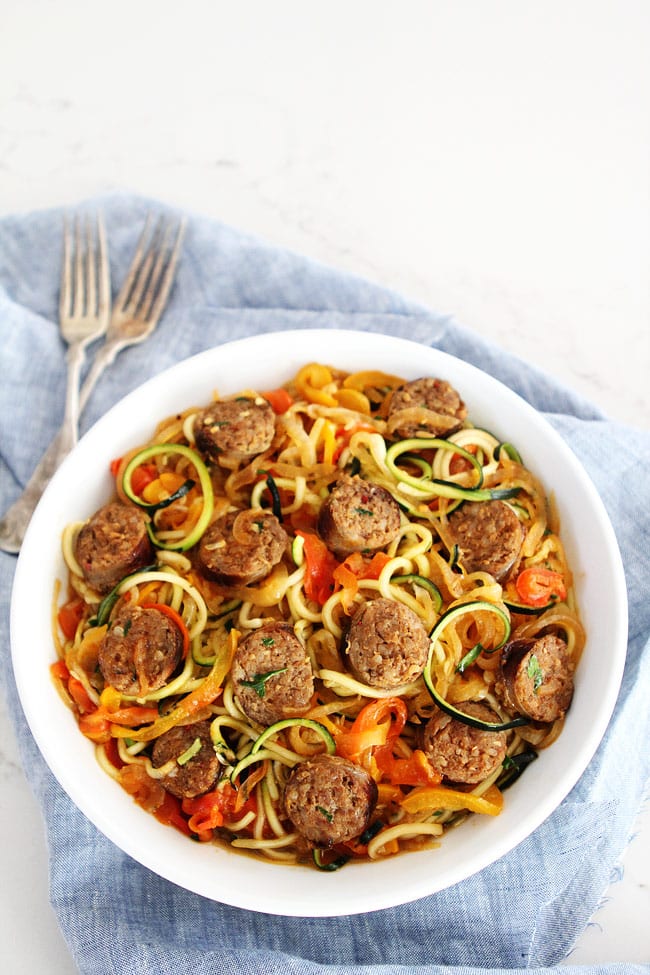 Sausage and Peppers with Zucchini Noodles Recipe on twopeasandtheirpod.com Sweet and spicy Italian sausage with peppers, onions, and zucchini noodles in a simple garlic tomato sauce. The entire family will love this quick and easy meal! Sausage and Peppers with Zucchini Noodles Recipe