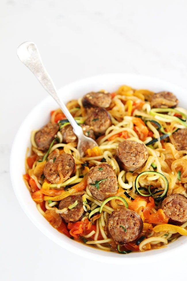 Sausage and Peppers with Zucchini Noodles Recipe on twopeasandtheirpod.com Sweet and spicy Italian sausage with peppers, onions, and zucchini noodles in a simple garlic tomato sauce. The entire family will love this quick and easy meal! Sausage and Peppers with Zucchini Noodles Recipe