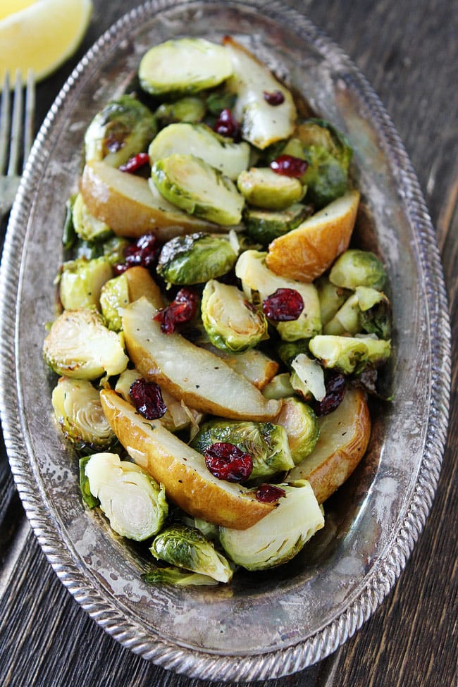 Roasted Pear and Cranberry Brussels Sprouts Recipe on twopeasandtheirpod.com Crispy Brussels sprouts with sweet roasted pears, dried cranberries, lemon, and honey. This simple side dish goes great with any meal. Roasted Pear and Cranberry Brussels Sprouts Recipe