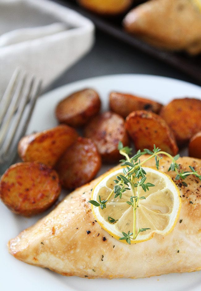 Sheet Pan Lemon Thyme Chicken with Smoked Paprika Potatoes Recipe on twopeasandtheiropd.com This easy and delicious sheet pan chicken dinner is made on ONE pan! It is a great weeknight meal. Sheet Pan Lemon Thyme Chicken with Smoked Paprika Potatoes Recipe