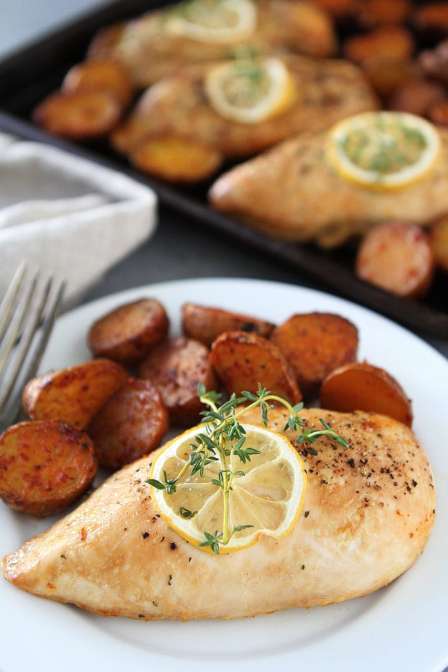 Sheet Pan Lemon Thyme Chicken with Smoked Paprika Potatoes Recipe on twopeasandtheiropd.com This easy and delicious sheet pan chicken dinner is made on ONE pan! It is a great weeknight meal. Sheet Pan Lemon Thyme Chicken Recipe