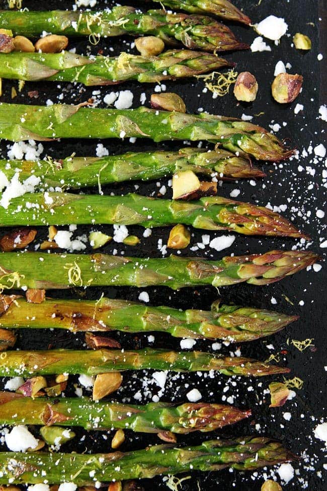 Roasted Asparagus with Lemon, Feta, and Pistachios Recipe on twopeasandtheirpod.com This is the BEST asparagus recipe and it's SO easy! Serve it for Easter or with any spring meal. Roasted Asparagus with Lemon, Feta, and Pistachios Recipe