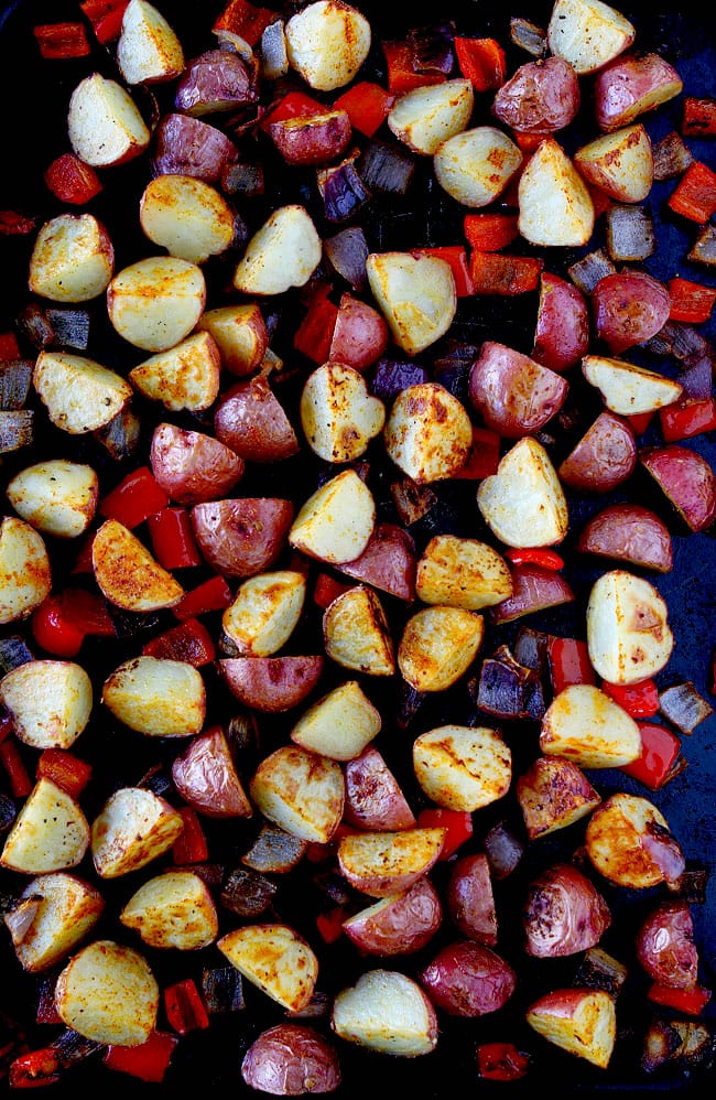 Roasted Breakfast Potatoes Recipe on twopeasandtheirpod.com These easy and crispy breakfast potatoes are roasted in the oven and made with ONE pan! They are the BEST! Roasted Breakfast Potatoes on baking sheet