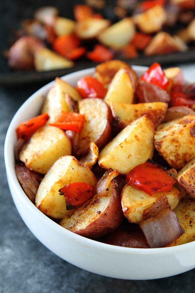 Roasted Breakfast Potatoes Recipe on twopeasandtheirpod.com These easy and crispy breakfast potatoes are roasted in the oven and SO good! They are a great side dish to any meal! Baked Breakfast Potatoes with onion and peppers
