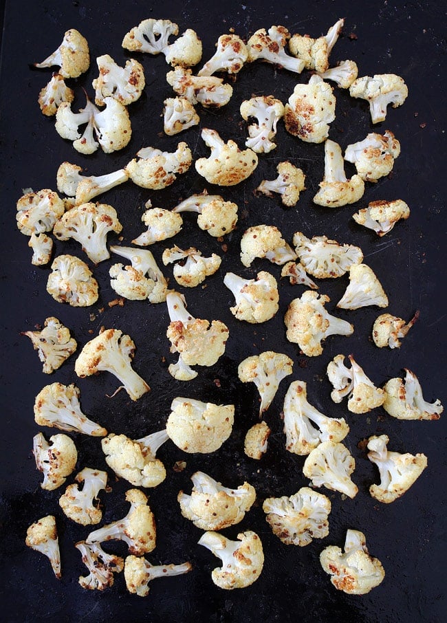 Roasted Mustard Cauliflower Recipe on twopeasandtheirpod.com Cauliflower tossed in olive oil, mustard, garlic, and lemon and roasted until crispy and caramelized. Everyone LOVES this easy cauliflower recipe! Roasted Mustard Cauliflower Recipe