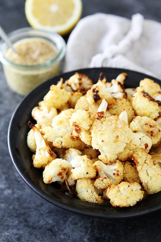 Roasted Mustard Cauliflower Recipe on twopeasandtheirpod.com This easy roasted cauliflower side dish goes great with any meal! It is a family favorite! Roasted Mustard Cauliflower Recipe