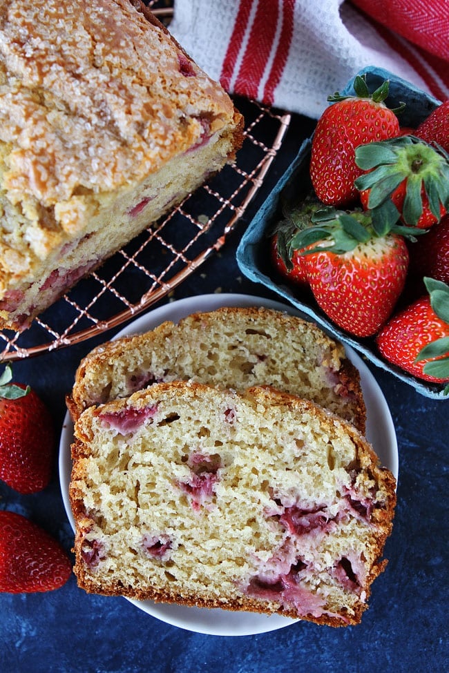 This easy Strawberry Quick Bread Recipe on twopeasandtheirpod.com is made with Greek yogurt, buttermilk, and fresh strawberries. It is tender, moist, and great for breakfast, brunch, or snacking. Strawberry Bread Recipe
