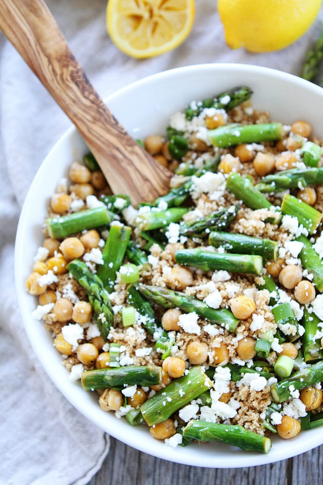 This easy Asparagus Chickpea Quinoa Salad with feta cheese and a simple lemon vinaigrette is perfect for spring. Enjoy it for lunch or dinner! Asparagus Chickpea Quinoa Salad in bowl with spoon