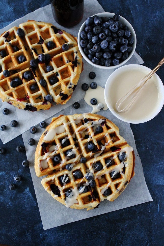 These light and fluffy Blueberry Sour Cream Waffles with a sweet maple glaze will make any morning better! Blueberry Sour Cream Waffles Recipe