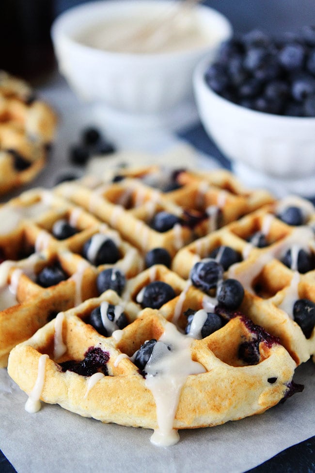 These light and fluffy Blueberry Sour Cream Waffles with a sweet maple glaze are perfect for breakfast or brunch. Blueberry Sour Cream Waffles close up
