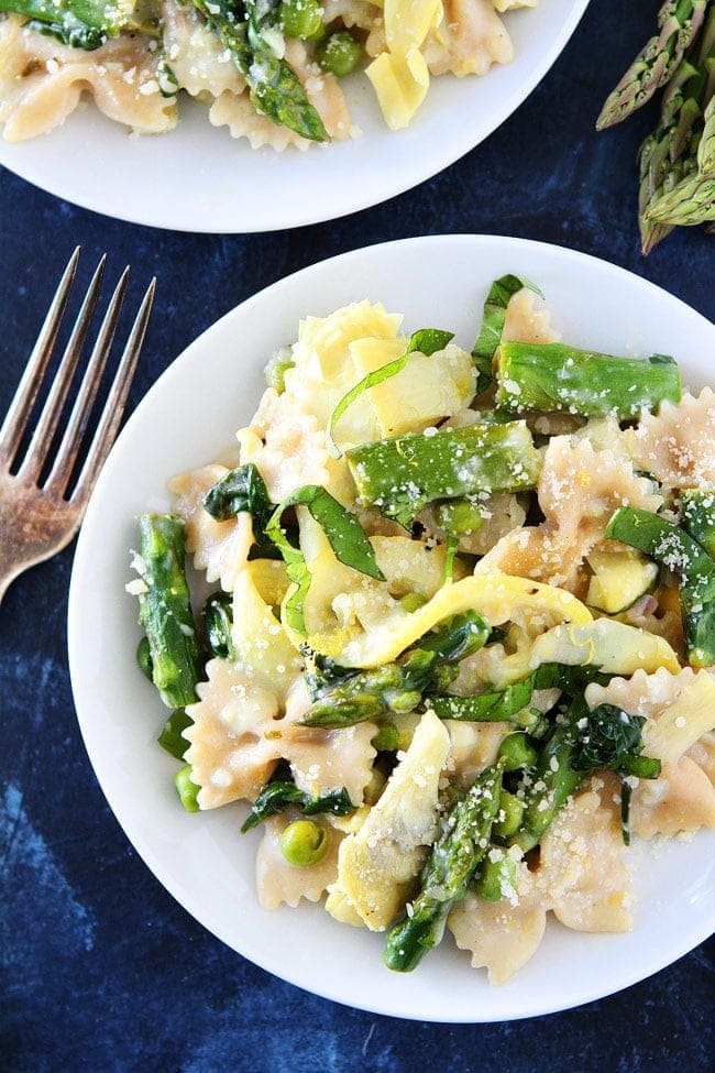 Creamy Lemon Spring Vegetable Pasta Recipe on twopeasandtheirpod.com This light and creamy lemon pasta with asparagus, artichokes, peas, and basil is perfect for spring! Creamy Lemon Spring Vegetable Pasta Recipe