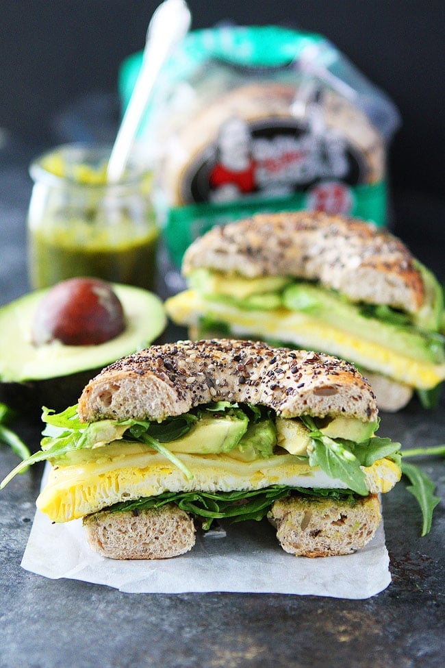 This easy Egg, Avocado, and Pesto Bagel Sandwich with cheese and arugula can be made in 10 minutes. It is the perfect easy breakfast or lunch! Egg, Avocado, and Pesto Bagel Sandwich Recipe.