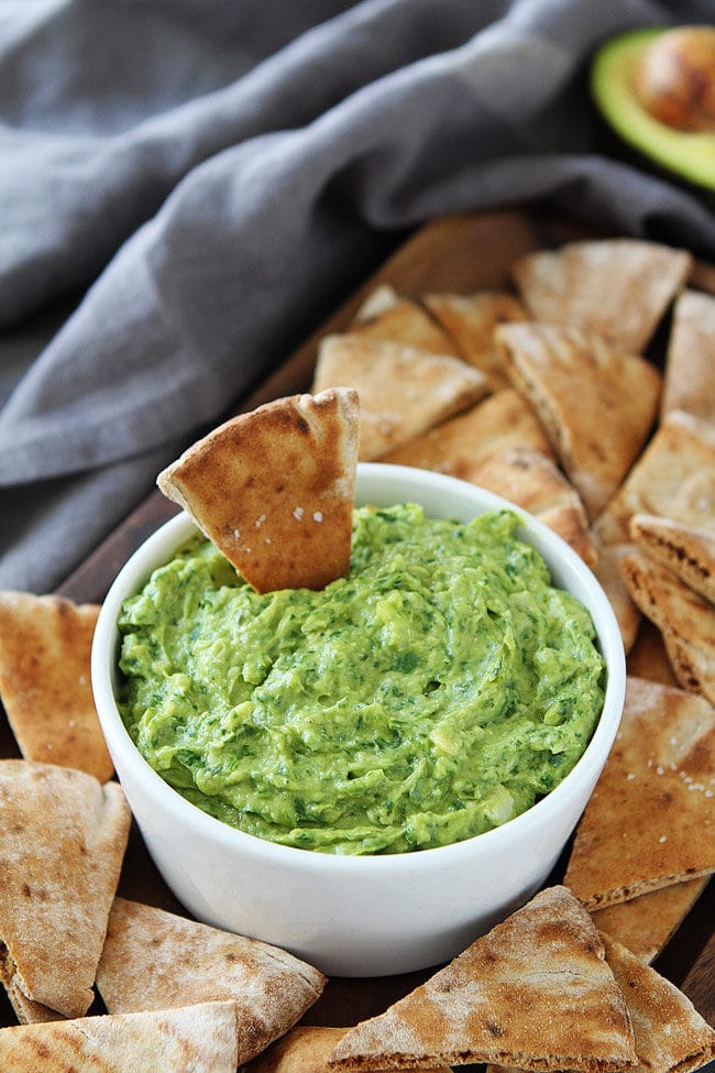 Avocado, Spinach, and Artichoke Dip is the perfect appetizer for parties or a great healthy snack! Serve with pita chips, crackers, or vegetables.