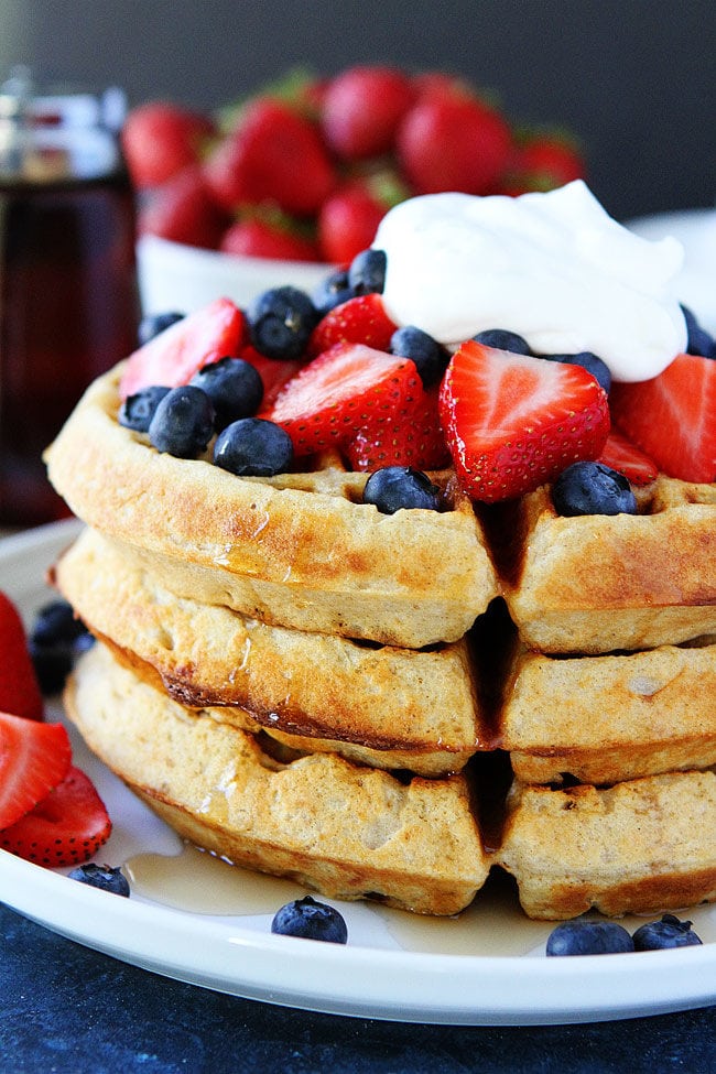 Belgian Waffles with berries, whipped cream, and maple syrup