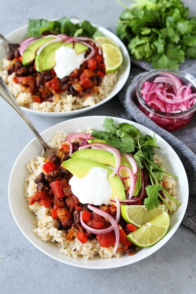 Black Bean Skillet Dinner with pickled onions and lime crema is a family favorite weeknight meal. It is easy, healthy, and full of flavor.