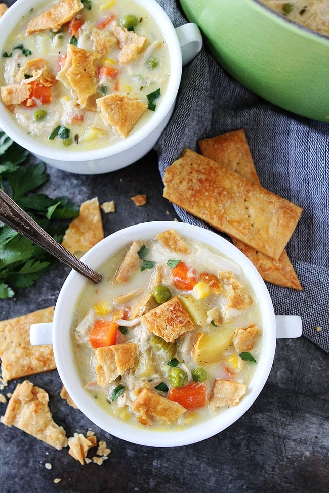 chicken pot pie soup in white bowls.
