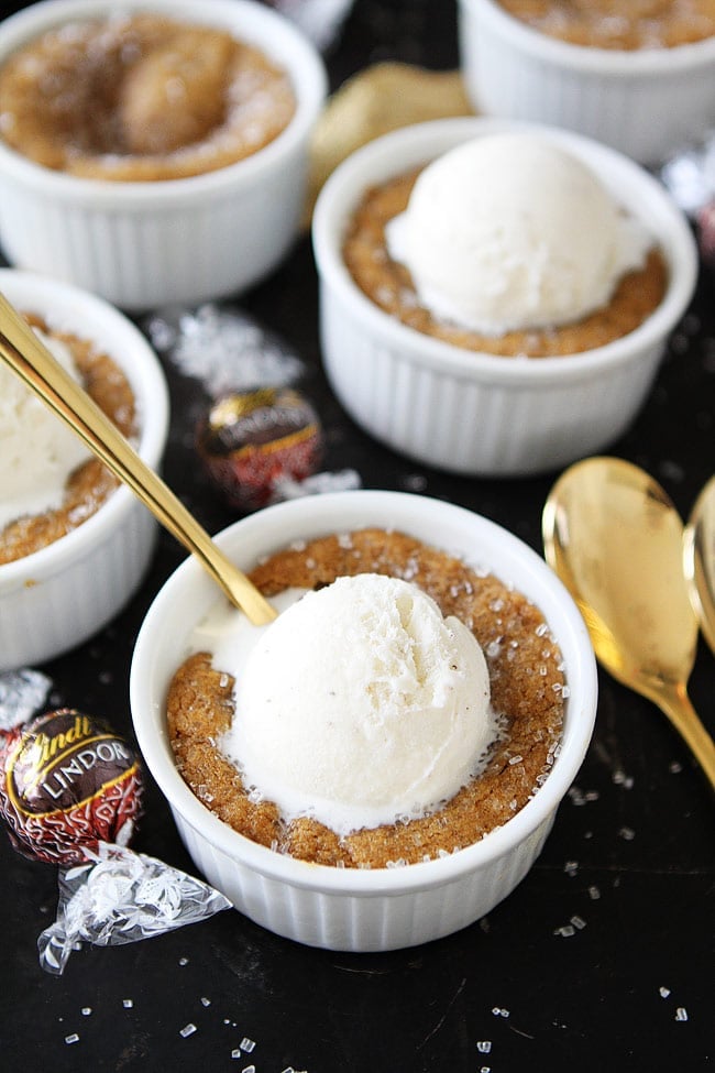 Deep Dish Gingerbread Truffle Cookies-molasses cookies baked in ramekins with a gingerbread milk chocolate truffle inside. Top with ice cream for the perfect holiday dessert!