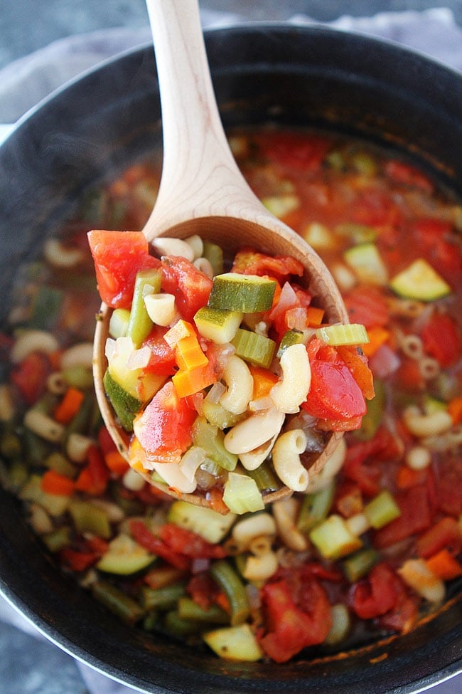 Easy Minestrone Recipe that is vegetarian and gluten-free. It is great for lunch or dinner! #soup #easyrecipes #vegetarian #glutenfree #healthyrecipes Minestrone soup in pot being served in a wooden ladle.
