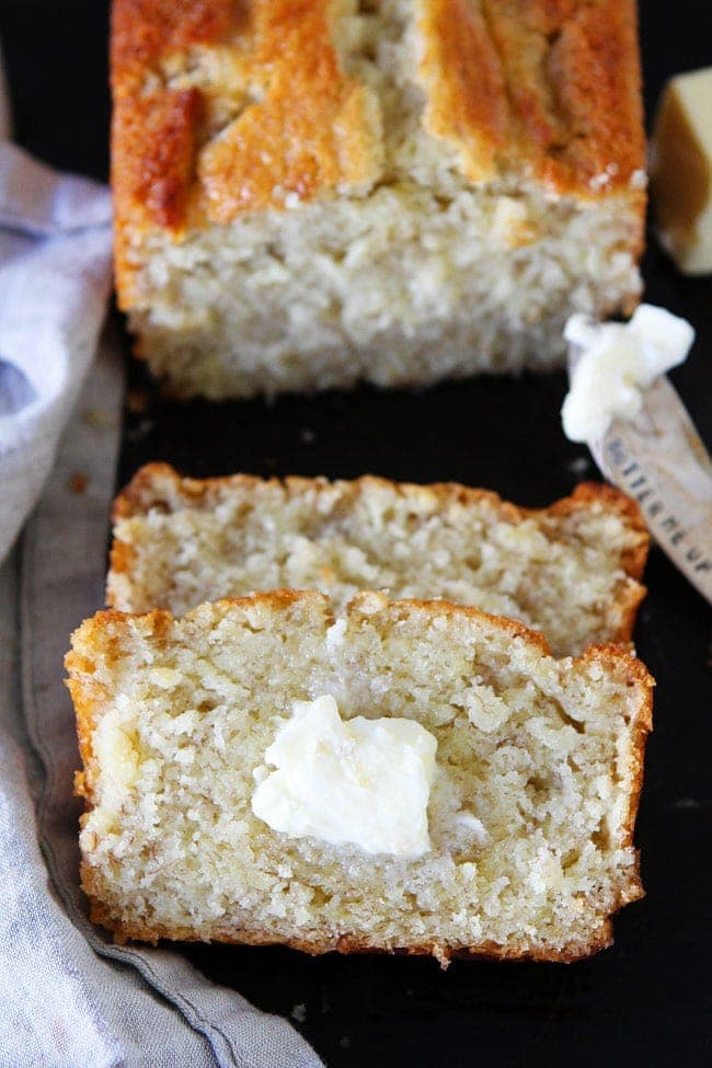 Buttermilk Banana Bread Recipe is the BEST banana bread! It is a family favorite! #bananas #bananabread #baking #bread #quickbread #buttermilk Buttermilk Banana Bread loaf sliced with butter.