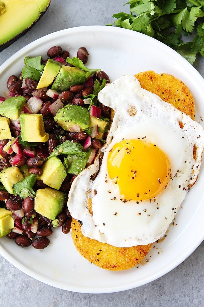 Polenta Rounds With Fried Eggs And Avocado Bean Salsa Is The Perfect Quick And Easy Meal. You Can Enjoy This Healthy And Satisfying Recipe For Breakfast, Lunch Or Dinner! #vegetarian #glutenfree #vegetarianrecipes #easyrecipe #healthyrecipe #healthyeating #eggs #beans #avocado #dinner #dinnerrecipes #breakfast Polenta Rounds with Eggs and Avocado Bean Salsa