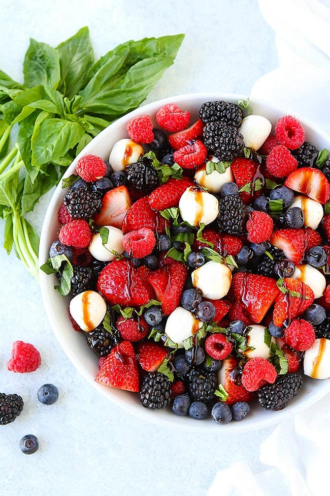 Berry Caprese Salad  in bowl with basil. 