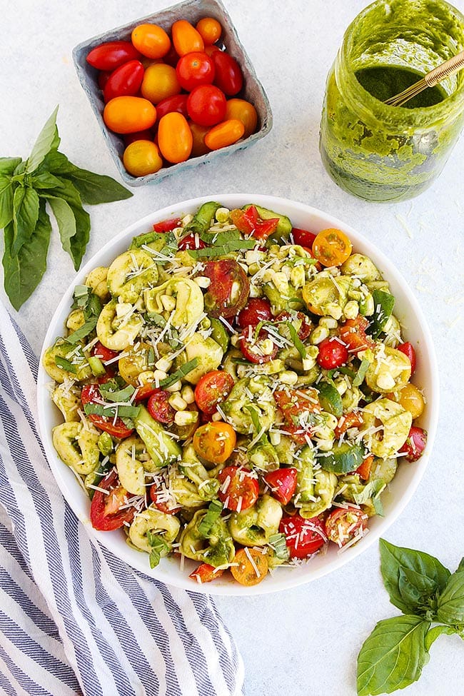Summer Tortellini Salad with tomatoes, corn, cucumbers, and basil vinaigrette! This cold pasta salad is a summer favorite! #summer #salad #pastasalad #tortellini #vegetarian #easyrecipe #recipe Summer Tortellini Salad Recipe