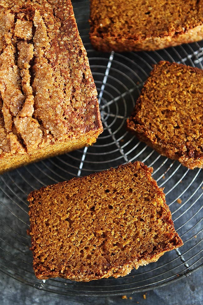 This Is The PERFECT Pumpkin Bread Recipe, It Is Moist, Perfectly Spiced, And Easy To Make. It Will Become One Of Your Favorite Fall Recipes! #pumpkin #bread #pumpkinbread #fall #recipe #easyrecipe #baking #pumpkinrecipe Pumpkin Bread slices on wire cooling rack.