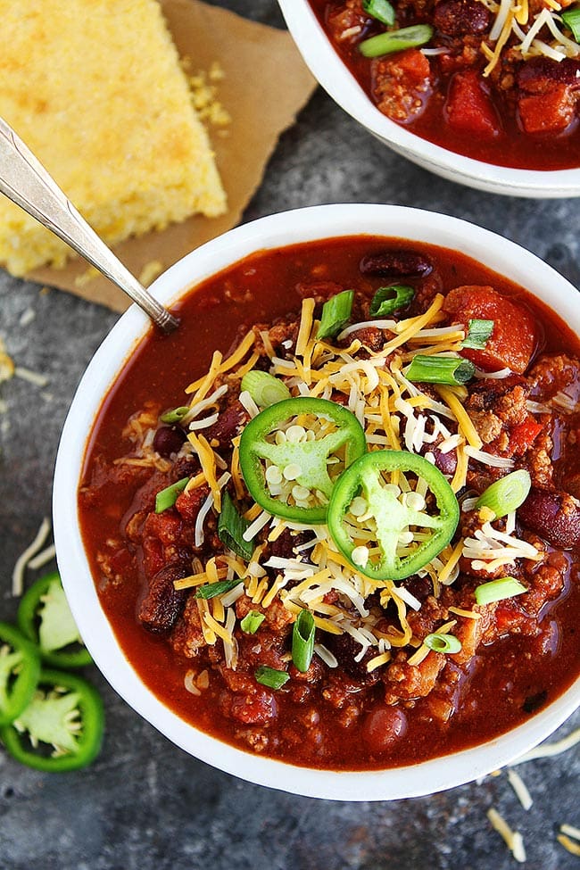 This easy Slow Cooker Beef Chili is a family favorite! Get out the crockpot and make it for dinner today! #chili #slowcooker #crockpot #dinner #easyrecipe #chilirecipe #fall #winter #gameday #glutenfree beef chili in bowl with spoon.