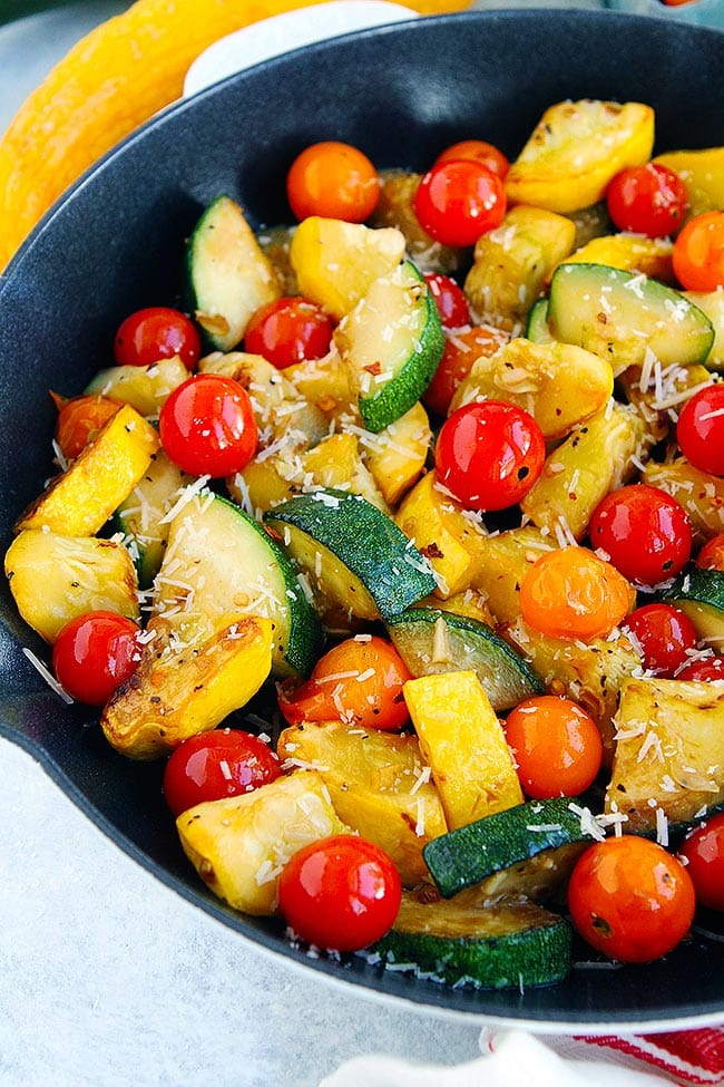Summer Squash Sauté with tomatoes, Parmesan cheese, and basil vinaigrette! The perfect simple summer side dish! #squash #summersquash #sidedish #easyrecipe #glutenfree #vegetarian #healthyrecipe #gardening #zucchini Summer Squash Sauté in Skillet