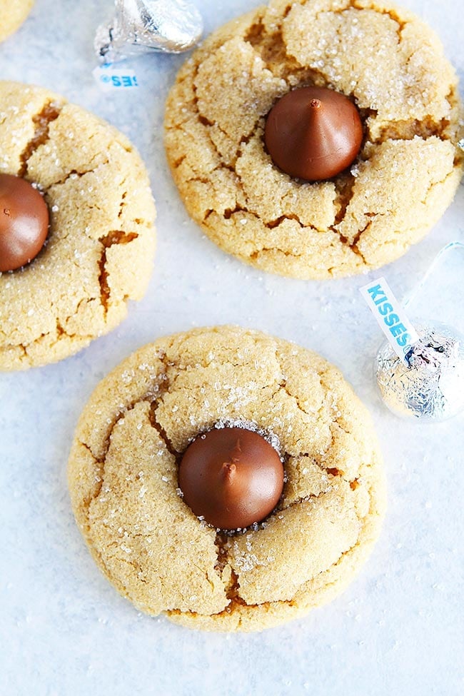 Peanut Butter Blossoms-Soft Peanut Butter Cookies Topped With A Chocolate Kiss Candy In The Center. These Easy Peanut Butter Cookies Are A Holiday Favorite! #cookies #Christmas #Christmascookies #holidays #baking #chocolate #peanutbutter Peanut Butter Blossom Cookies with Hershey's chocolate kiss in the center.
