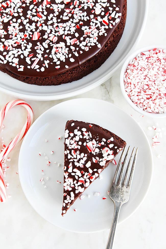This Decadent Peppermint Flourless Chocolate Cake Is The Perfect Dessert For The Holiday Season. The Crushed Peppermint Candies Are The Perfect Finishing Touch To This Festive Gluten-Free Chocolate Cake. #cake #chocolatecake #glutenfree #dessert #Christmas #holidays #peppermint #mint #baking Easy Peppermint Flourless Chocolate Cake